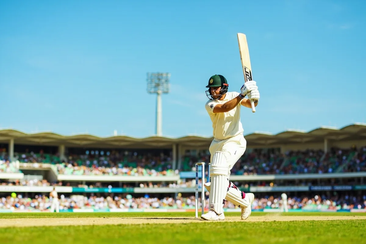 Cricket batsman hitting a six over mid-wicket