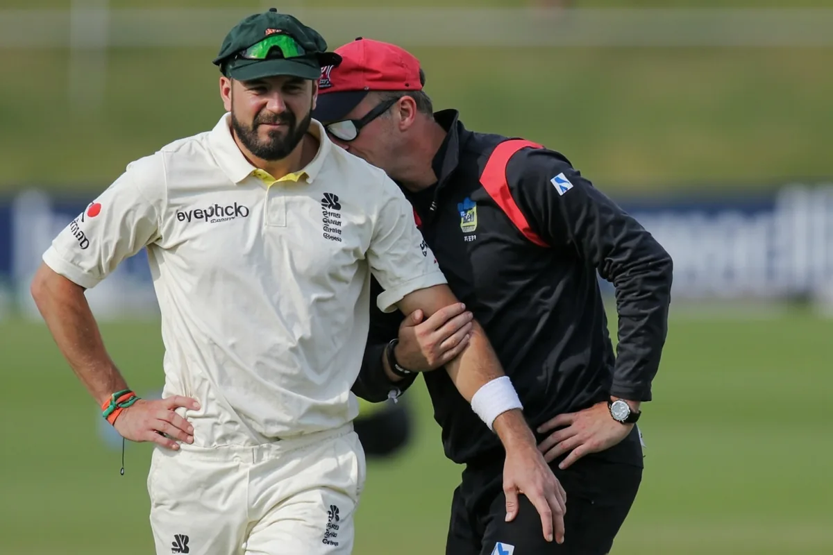 Cricket player receiving treatment from physiotherapist